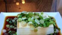 Steamed tofu with sweet soy dressing sauce and spring onions Steamed tofu with sweet soy dressing sauce and spring onions
