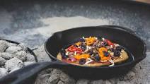 Cast-iron fire-cooked pizza Cast-iron fire-cooked pizza