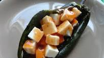 Chiles rellenos de queso panela bañados de salsa de tomate. Chiles rellenos de queso panela bañados de salsa de tomate.