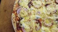 Pizza with cheese, ham, mushrooms and cherry tomatoes Pizza with cheese, ham, mushrooms and cherry tomatoes
