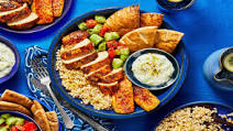 Mediterranean Mezze Platter with Baked Chicken, Grilling Cheese, Tomato Cucumber Salad, and Pita Chips Mediterranean Mezze Platter with Baked Chicken, Grilling Cheese, Tomato Cucumber Salad, and Pita Chips
