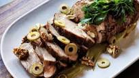 Slow-roasted pork neck, green olive sauce, parsley and walnuts Slow-roasted pork neck, green olive sauce, parsley and walnuts