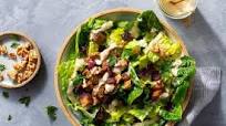 Pork chop salad with dried cranberries, walnuts, and Caesar dressing Pork chop salad with dried cranberries, walnuts, and Caesar dressing