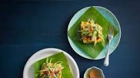 Steamed sea bass wrapped in banana leaves with green mango salad Steamed sea bass wrapped in banana leaves with green mango salad