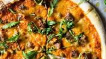 Pizza with sausage and roasted red pepper sauce Pizza with sausage and roasted red pepper sauce