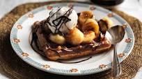 Waffles with hot chocolate sauce, fried bananas and ice cream Waffles with hot chocolate sauce, fried bananas and ice cream