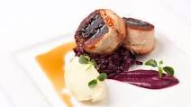 Confit belly of pork stuffed with black pudding with braised red cabbage, mash and cider jus Confit belly of pork stuffed with black pudding with braised red cabbage, mash and cider jus
