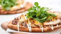 Wood-Fired BBQ Chicken Pizza with caramelized onions and ranch drizzle Wood-Fired BBQ Chicken Pizza with caramelized onions and ranch drizzle
