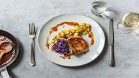 Bone-In Pork Loin Chops Drizzled in Cracked Peppercorn Sauce with Butter-Braised Apples and Cabbage Bone-In Pork Loin Chops Drizzled in Cracked Peppercorn Sauce with Butter-Braised Apples and Cabbage