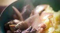 Beef stew marinated in red wine with onions and mushrooms Beef stew marinated in red wine with onions and mushrooms
