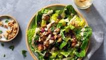 Pork chop salad with dried cranberries, walnuts, and Caesar dressing Pork chop salad with dried cranberries, walnuts, and Caesar dressing