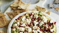 Layered hummus with spiced tortilla chips Layered hummus with spiced tortilla chips