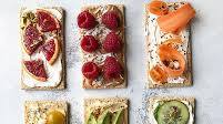 Crackers Topped With Yogurt, Hummus, Avocado, And Fresh Fruit Crackers Topped With Yogurt, Hummus, Avocado, And Fresh Fruit