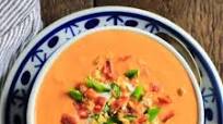 Tomato Basil Bisque soup with bacon, sautéed garlic and green onions Tomato Basil Bisque soup with bacon, sautéed garlic and green onions
