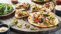 White Bean Hummus Flatbread with Crispy Brussels and Roasted Red Peppers White Bean Hummus Flatbread with Crispy Brussels and Roasted Red Peppers