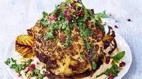 Whole roasted cauliflower with hummus and green herb dressing recipe Whole roasted cauliflower with hummus and green herb dressing recipe