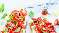 Tomato bruschetta with mozzarella and anchovies Tomato bruschetta with mozzarella and anchovies