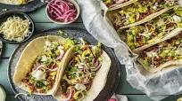 Pork Carnitas Tacos with Lettuce, Onion, and a Lime Crema Pork Carnitas Tacos with Lettuce, Onion, and a Lime Crema