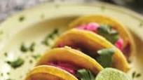 Slow cooked pig cheek carnitas with a garnish of pickled red onions Slow cooked pig cheek carnitas with a garnish of pickled red onions