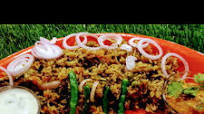 Hyderabadi biryani with mirch ka salan and garlic mint raita Hyderabadi biryani with mirch ka salan and garlic mint raita