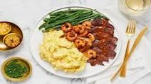 Sirloin topped with Lemon-Paprika Shrimp plus Crème Fraîche Mashed Potatoes & Roasted Green Beans Sirloin topped with Lemon-Paprika Shrimp plus Crème Fraîche Mashed Potatoes & Roasted Green Beans