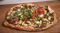 Turkish pizza with spicy minced beef and salad topping (lahmacun) Turkish pizza with spicy minced beef and salad topping (lahmacun)