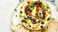 Warm hummus with pine nuts, raisins and olives Warm hummus with pine nuts, raisins and olives