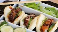 Succulent and Crispy Pork Belly on Chinese Steamed Buns with Pickled Cucumbers and Hoisin Sauce Succulent and Crispy Pork Belly on Chinese Steamed Buns with Pickled Cucumbers and Hoisin Sauce