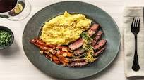 Rib-Eye Steak Over Gruyère Mashed Potatoes with Roasted Carrots, Hazelnuts, and Dijon Butter Rib-Eye Steak Over Gruyère Mashed Potatoes with Roasted Carrots, Hazelnuts, and Dijon Butter