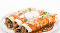 Cheesy Chipotle Steak Enchiladas with sour cream and cilantro Cheesy Chipotle Steak Enchiladas with sour cream and cilantro