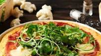 Pizza sans gluten, pâte de chou-fleur, mozzarella, champignons et roquette Pizza sans gluten, pâte de chou-fleur, mozzarella, champignons et roquette