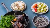 Beef short rib birria tacos with black beans and chipotle jus Beef short rib birria tacos with black beans and chipotle jus