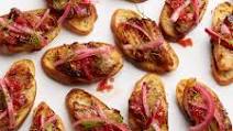 Roast Pork Belly Toasts with Blood-Orange BBQ Sauce and Pickled Red Onion Recipe Roast Pork Belly Toasts with Blood-Orange BBQ Sauce and Pickled Red Onion Recipe