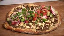 Turkish pizza with spicy minced beef and salad topping (lahmacun) Turkish pizza with spicy minced beef and salad topping (lahmacun)