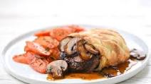Steak Wellington with roasted carrots and mushroom demi-glace Steak Wellington with roasted carrots and mushroom demi-glace