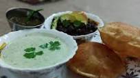 Kale chane, bathua ka raita with poori Kale chane, bathua ka raita with poori