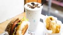 8Bit's burger with cheese, beer battered onion rings and peanut butter milkshake 8Bit's burger with cheese, beer battered onion rings and peanut butter milkshake