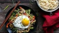 Stir-fried egg noodles with sesame sauce and a fried egg Stir-fried egg noodles with sesame sauce and a fried egg