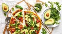 Herb crusted Polenta Pizza base topped with Avocado and pesto Herb crusted Polenta Pizza base topped with Avocado and pesto