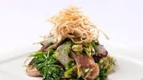 Honey marinated duck breast with sautéed greens and crispy noodles Honey marinated duck breast with sautéed greens and crispy noodles