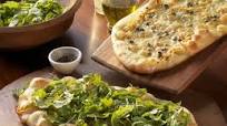 Grilled Pizzas with Brie, Caramelized Onions and Capers Grilled Pizzas with Brie, Caramelized Onions and Capers