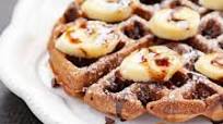 Chocolate Belgian waffles with banana and syrup Chocolate Belgian waffles with banana and syrup