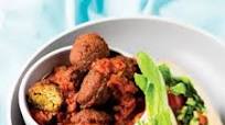 Falafel in spicy tomato sauce with salad-stuffed pitas Falafel in spicy tomato sauce with salad-stuffed pitas