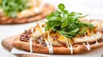 Wood-Fired BBQ Chicken Pizza with caramelized onions and ranch drizzle Wood-Fired BBQ Chicken Pizza with caramelized onions and ranch drizzle