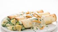 Spinach and Artichoke Alfredo Enchiladas with crispy onions and parsley Spinach and Artichoke Alfredo Enchiladas with crispy onions and parsley