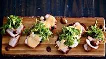 Pork Belly Eggs Benedict with Miso Hollandaise topped with a Black Garlic and Pepper Arugula Salad on Pumpernickel Toast Pork Belly Eggs Benedict with Miso Hollandaise topped with a Black Garlic and Pepper Arugula Salad on Pumpernickel Toast