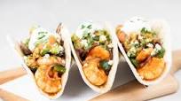 Chipotle-Tomato Shrimp Tacos with guacamole and cotija cheese Chipotle-Tomato Shrimp Tacos with guacamole and cotija cheese