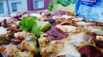 Delicious pizza with curd cream, figs and sujuk Delicious pizza with curd cream, figs and sujuk